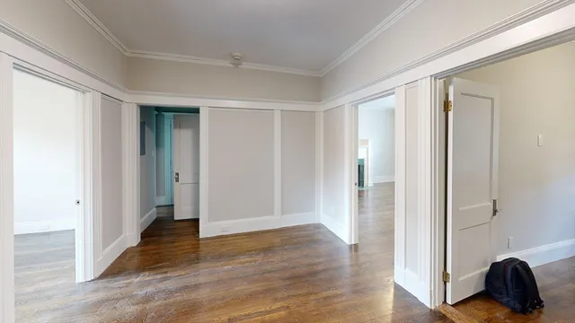 a view of a livingroom with wooden floor and closet
