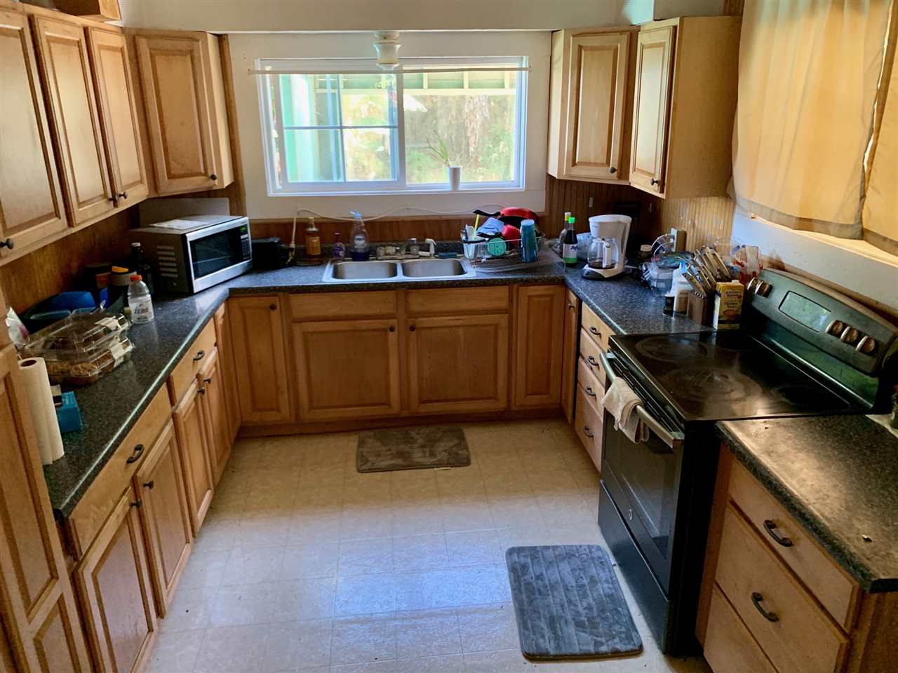 397 Middle Road Kula, HI 96790 - Photo 3 of 10 a kitchen with a sink stove and cabinets