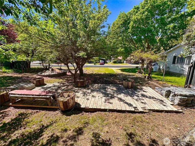 a view of swimming pool with lawn chairs and plants