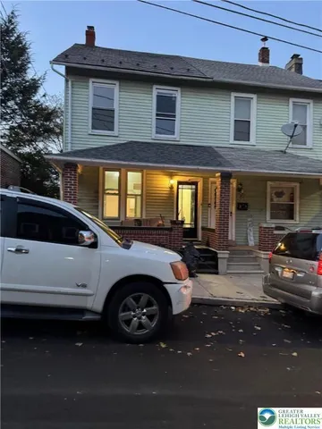a view of a car park in front of a house