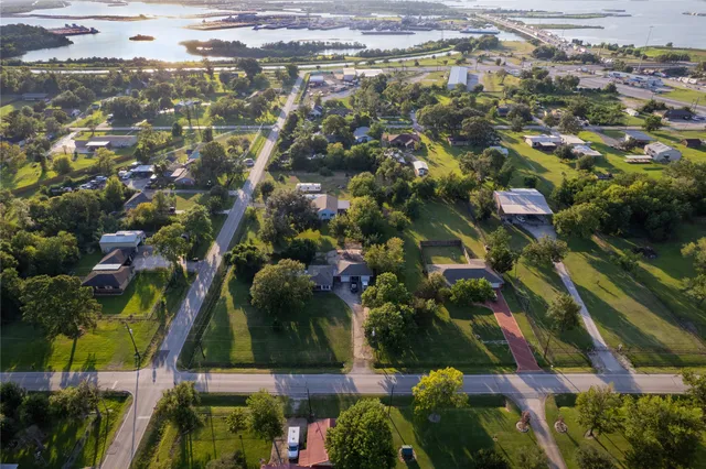 an aerial view of residential houses with outdoor space and street view