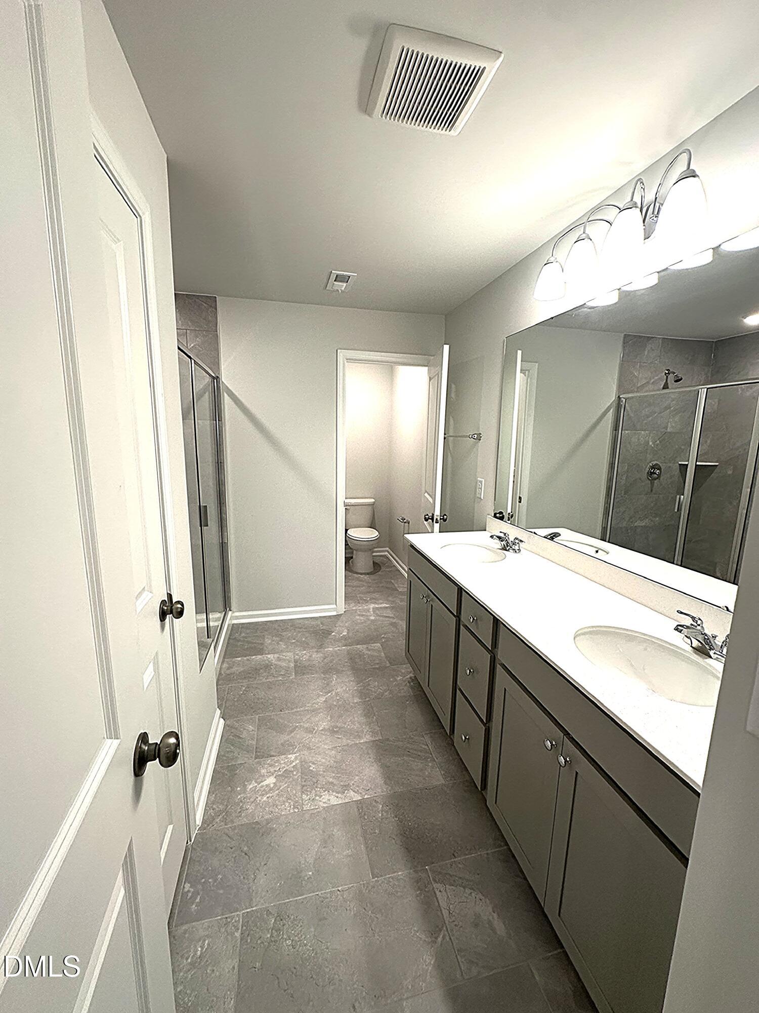 295 Glenmore Gardens Road Raleigh, NC 27603 - Photo 17 of 30 a bathroom with a sink a vanity and a mirror