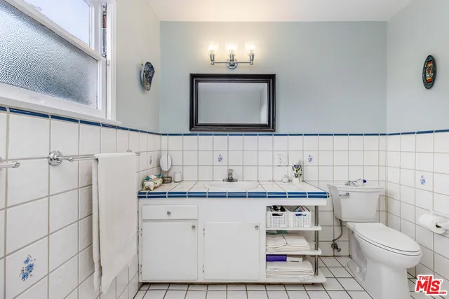 a bathroom with a sink toilet and mirror