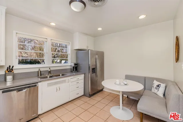 a kitchen with a sink cabinets and appliances
