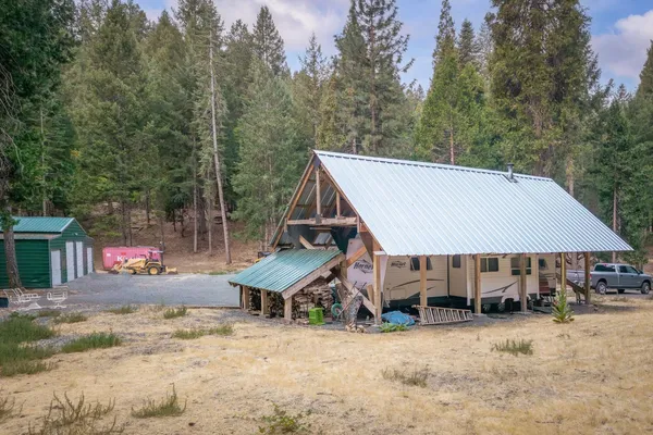 a view of a house with a yard and sitting area