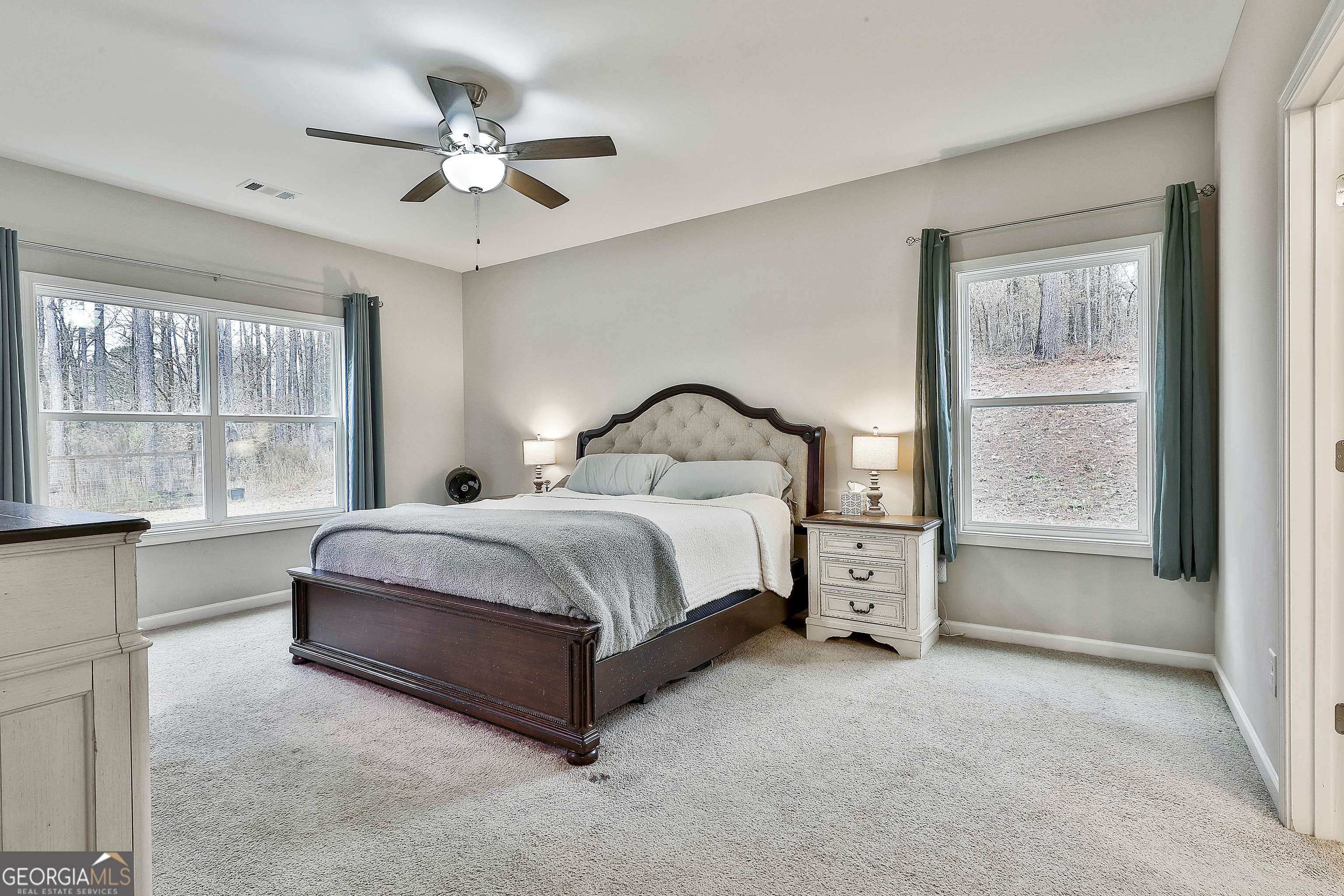 250 Mobley Bridge Road LaGrange, GA 30241 - Photo 23 of 42 a spacious bedroom with a large bed and a large window
