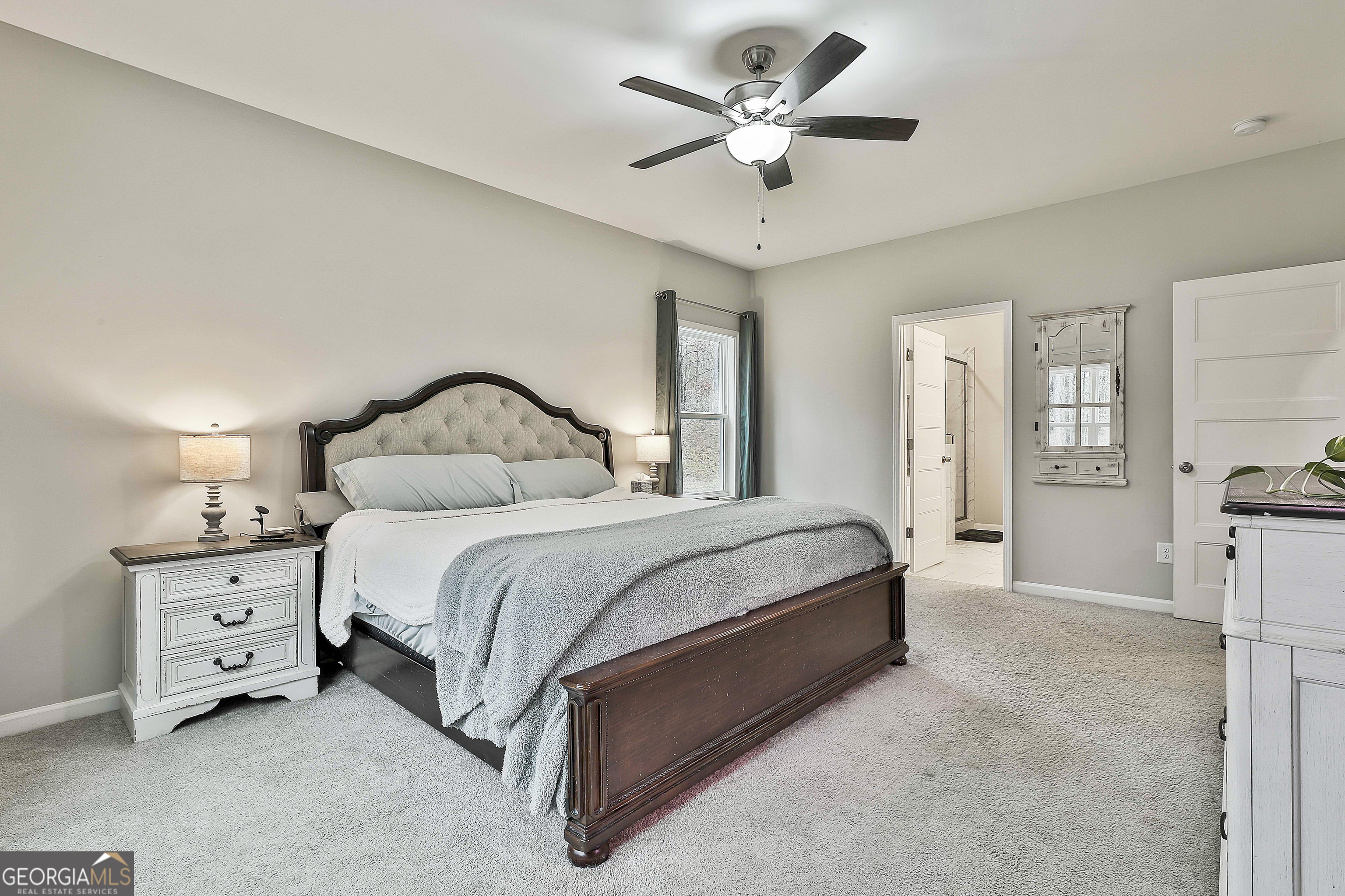 250 Mobley Bridge Road LaGrange, GA 30241 - Photo 25 of 42 a bedroom with a bed and a chandelier