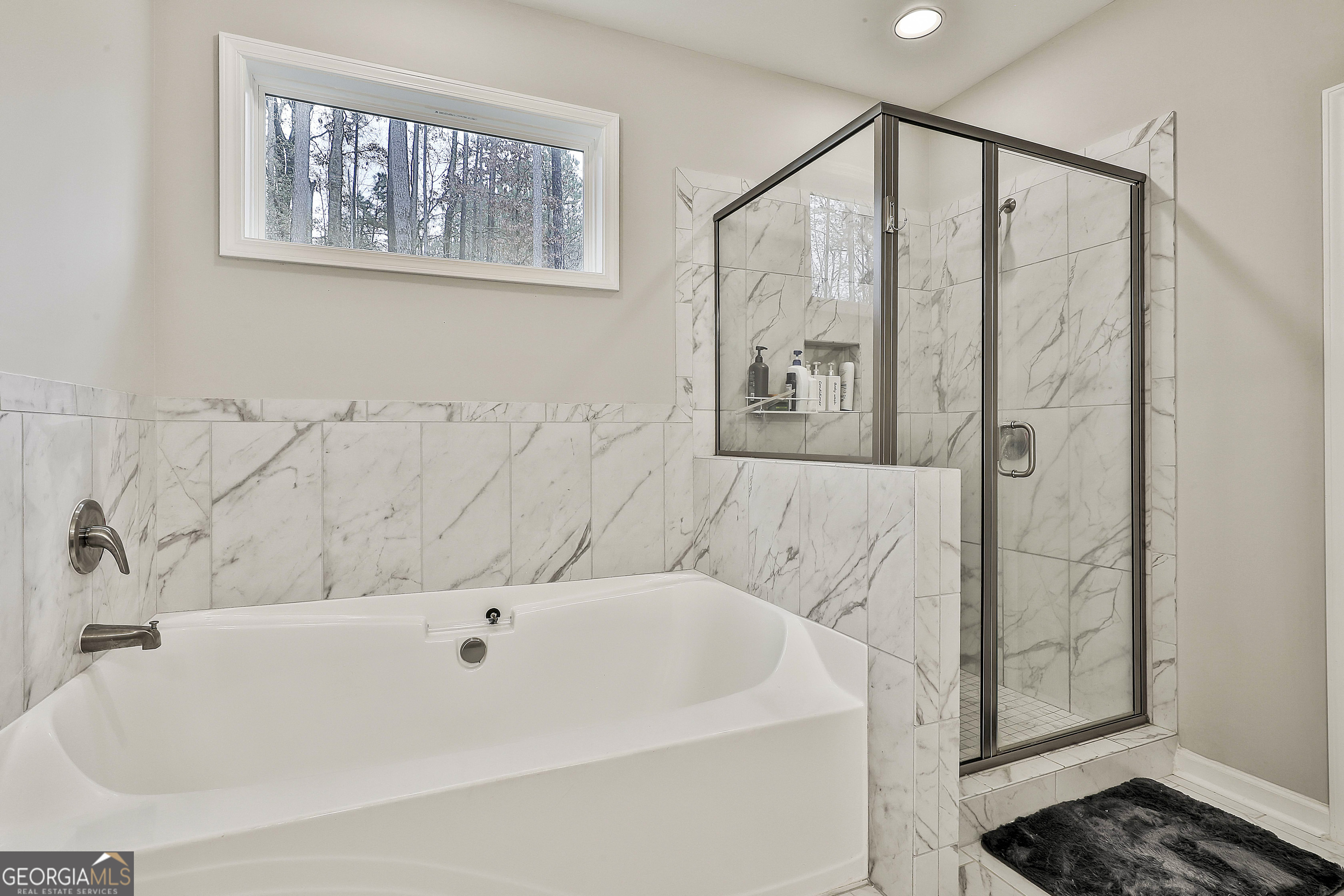 250 Mobley Bridge Road LaGrange, GA 30241 - Photo 27 of 42 a bathroom with a bathtub and a shower