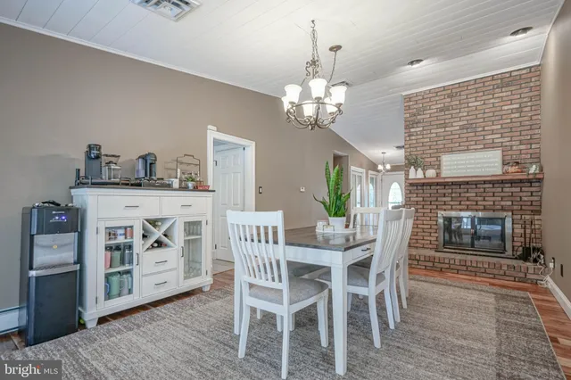 a view of a dining room with furniture and chandelier