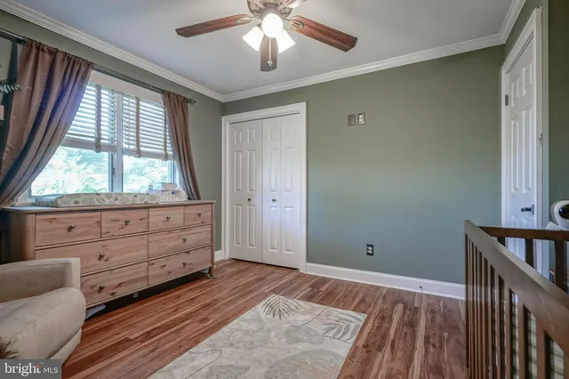 a bathroom with a granite countertop sink a toilet and mirror