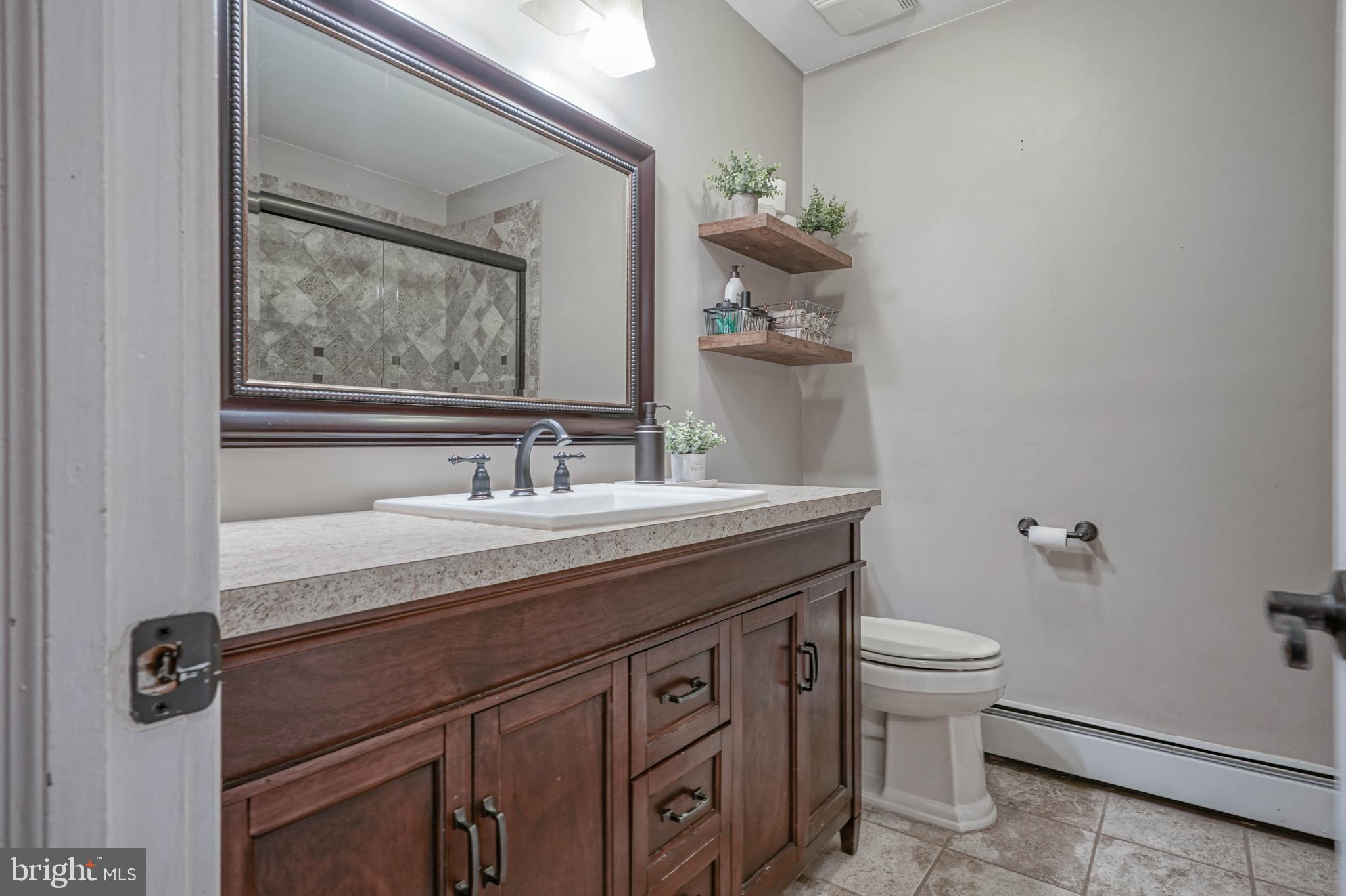 750 Moss Mill Road Hammonton, NJ 08037 - Photo 28 of 57 a bathroom with a granite countertop sink a toilet and mirror
