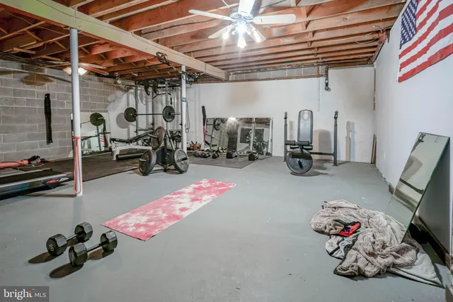 a view of a patio with couches chairs and wooden floor