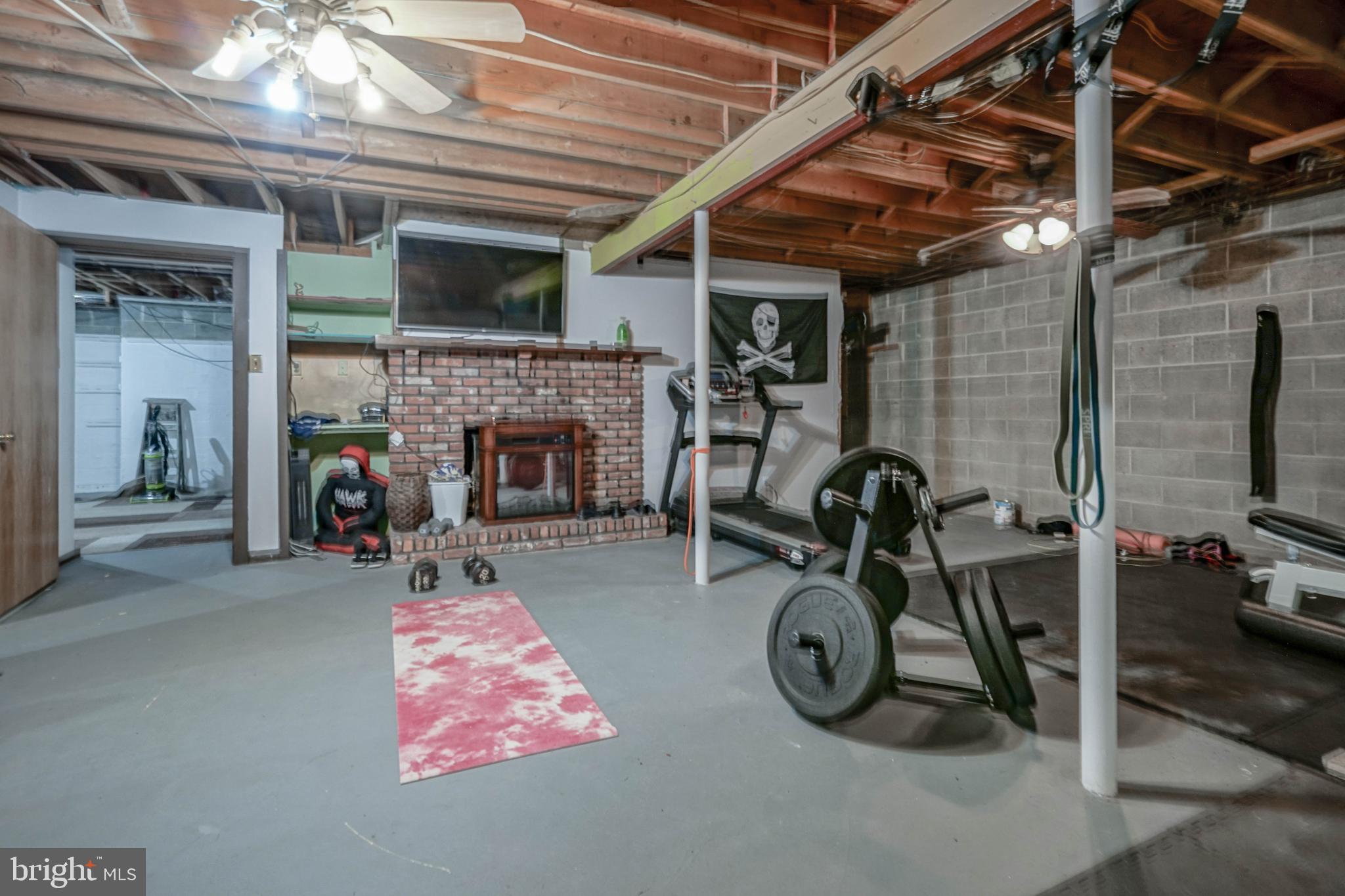 750 Moss Mill Road Hammonton, NJ 08037 - Photo 36 of 57 a living room with furniture a flat screen tv and a fireplace