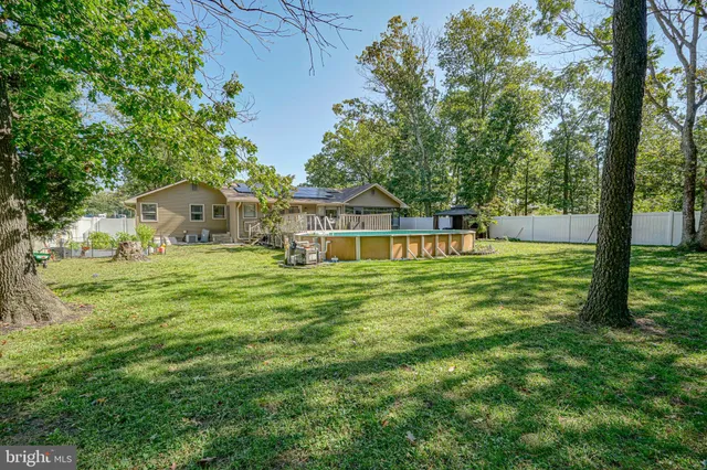 an aerial view of residential house with outdoor space and parking
