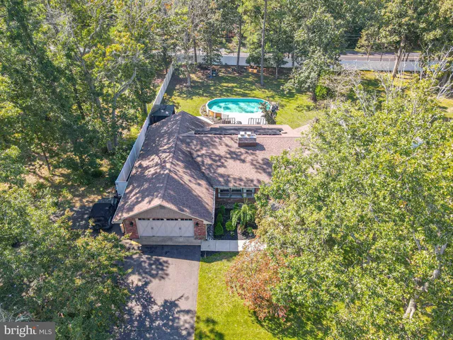 an aerial view of a house with swimming pool garden and patio