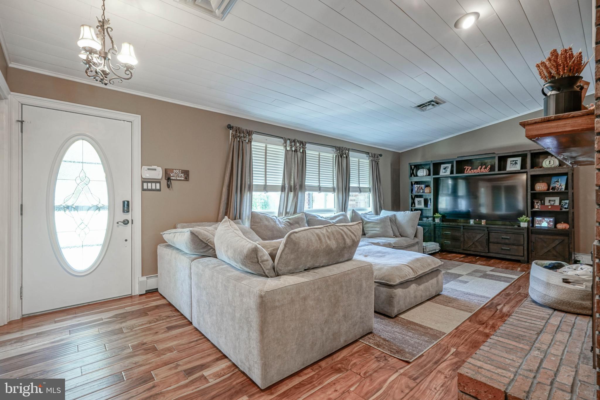 750 Moss Mill Road Hammonton, NJ 08037 - Photo 7 of 57 a living room with furniture and a chandelier