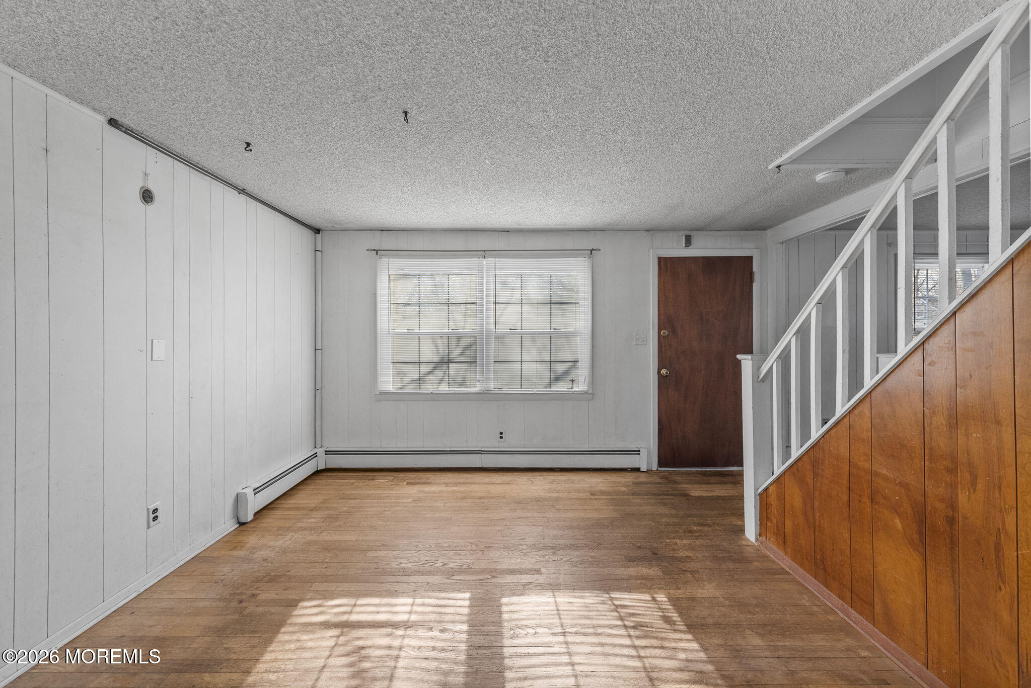 517 Middle Lane Howell, NJ 07731 - Photo 12 of 31 a view of an empty room with wooden floor and stairs