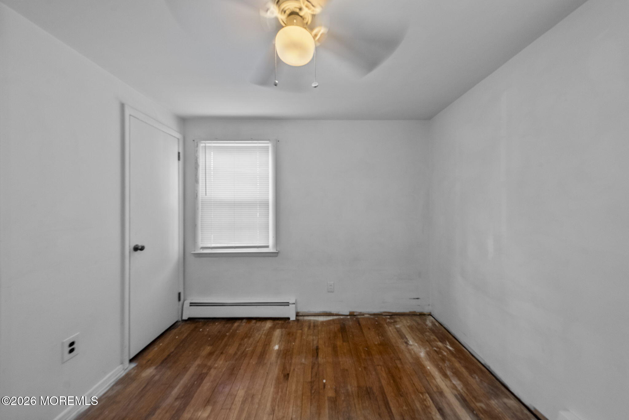 517 Middle Lane Howell, NJ 07731 - Photo 17 of 31 a view of an empty room with wooden floor and a window