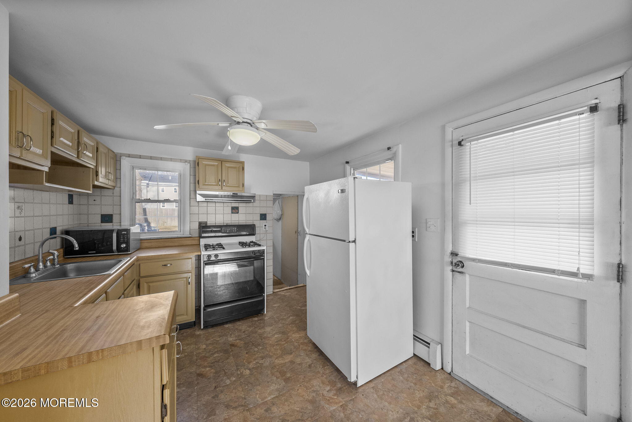 517 Middle Lane Howell, NJ 07731 - Photo 3 of 31 a kitchen with cabinets and stainless steel appliances