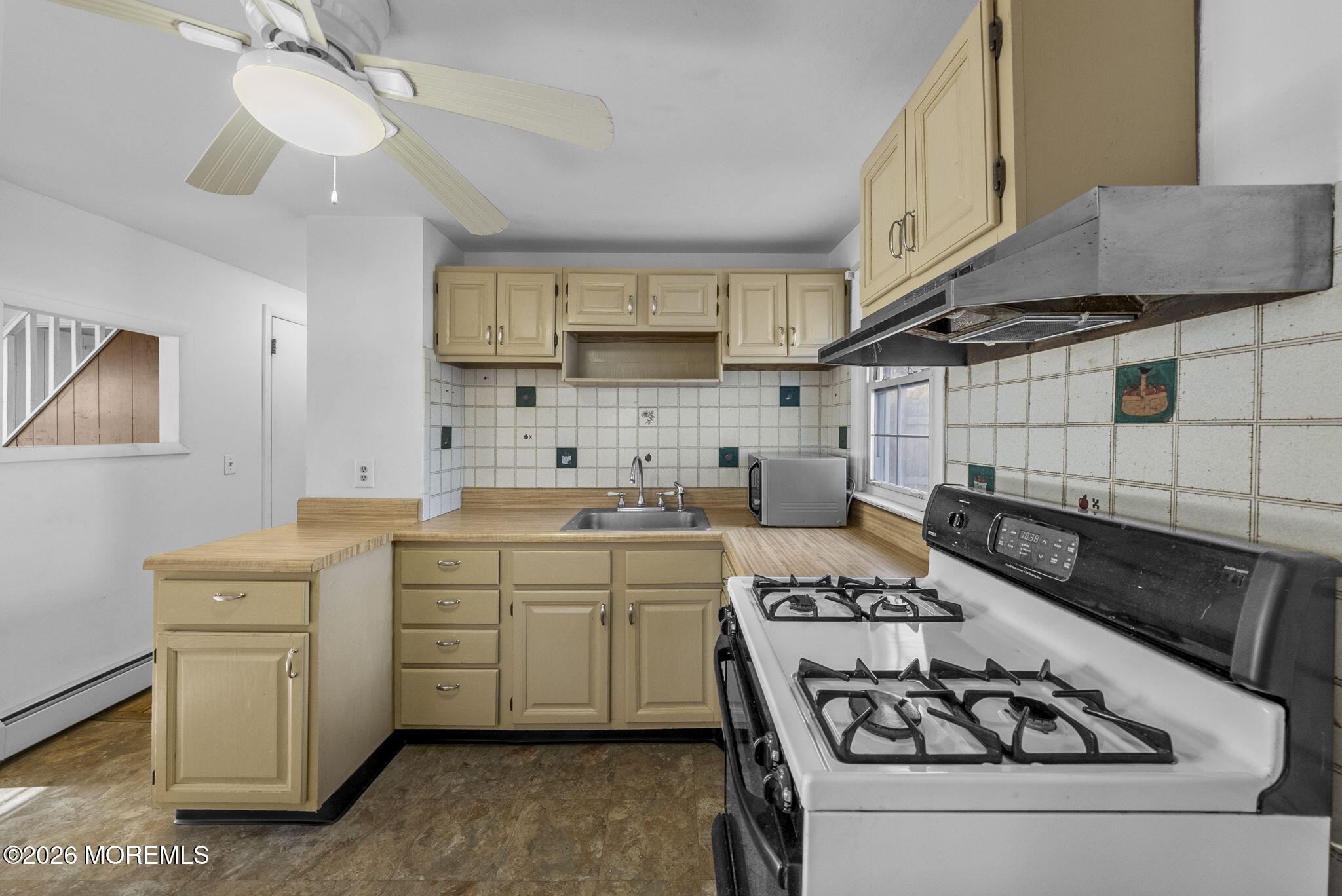 517 Middle Lane Howell, NJ 07731 - Photo 4 of 31 a kitchen with sink a stove and cabinets