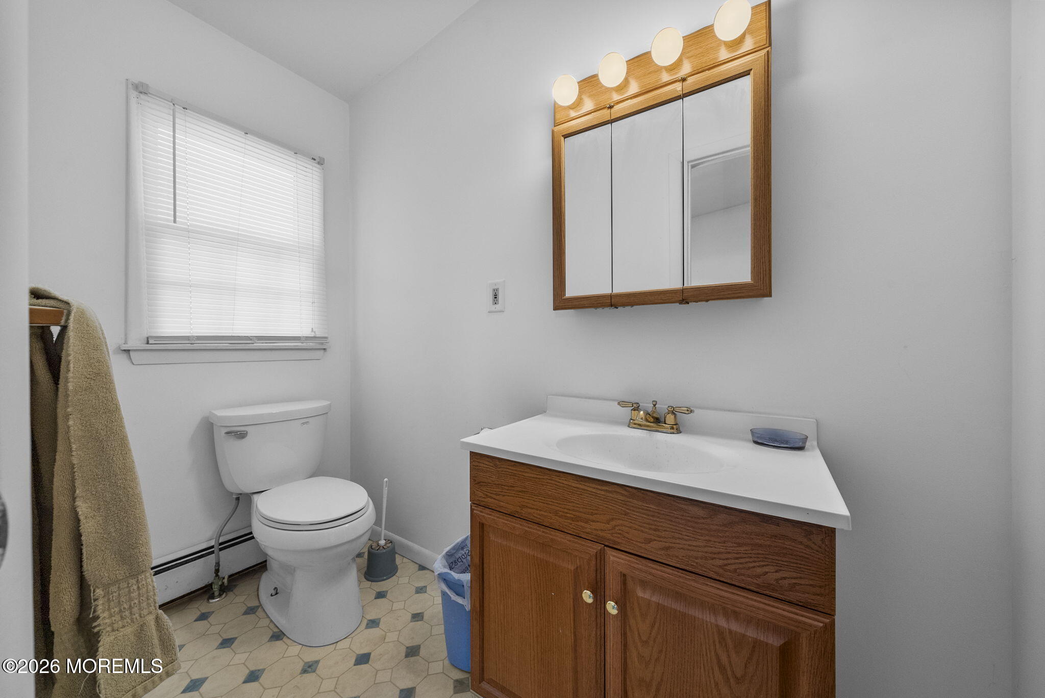 517 Middle Lane Howell, NJ 07731 - Photo 6 of 31 a bathroom with a sink a toilet and mirror