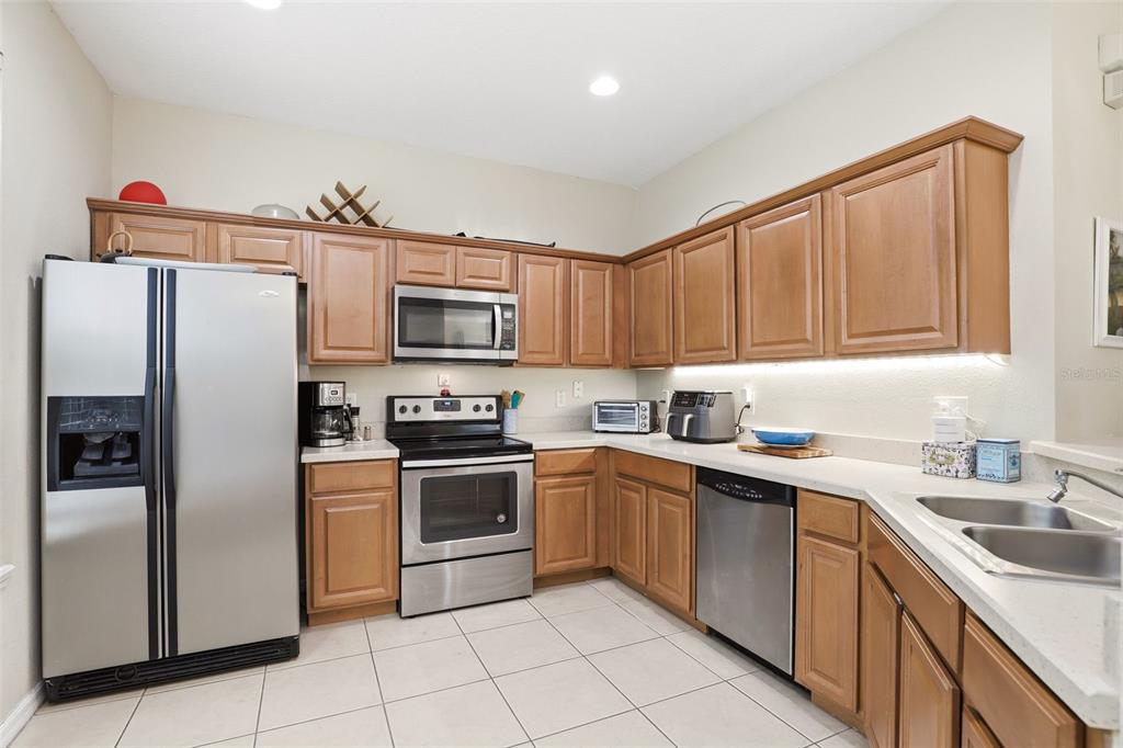 6458 South Goldenrod Road, Unit 29B Orlando, FL 32822 - Photo 14 of 40 a kitchen with stainless steel appliances granite countertop a refrigerator sink and stove