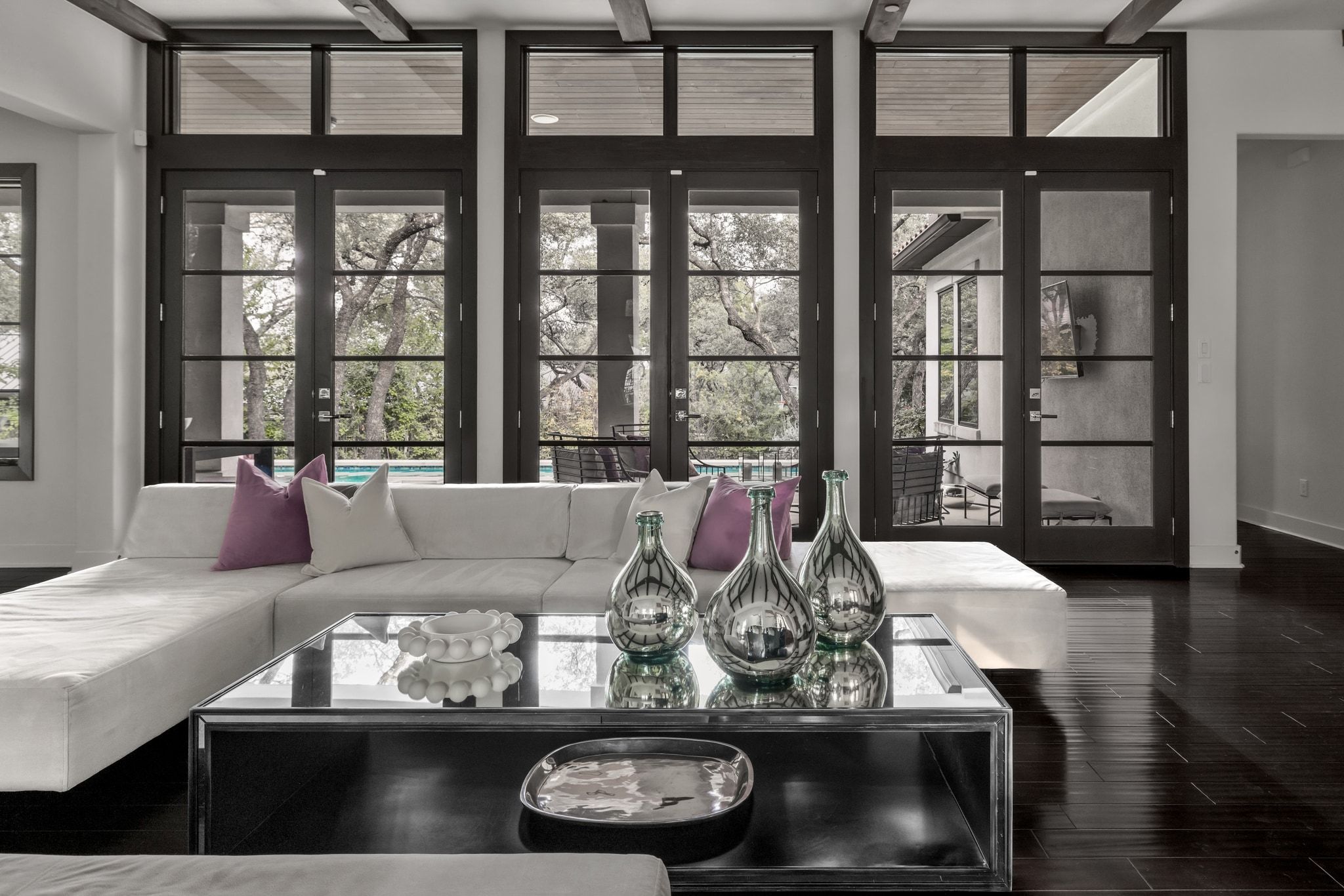 4720 Rockcliff Road, Unit 1 Austin, TX 78746 - Photo 9 of 39 Floor-to-ceiling French doors frame verdant outdoor living, creating a seamless connection to nature.