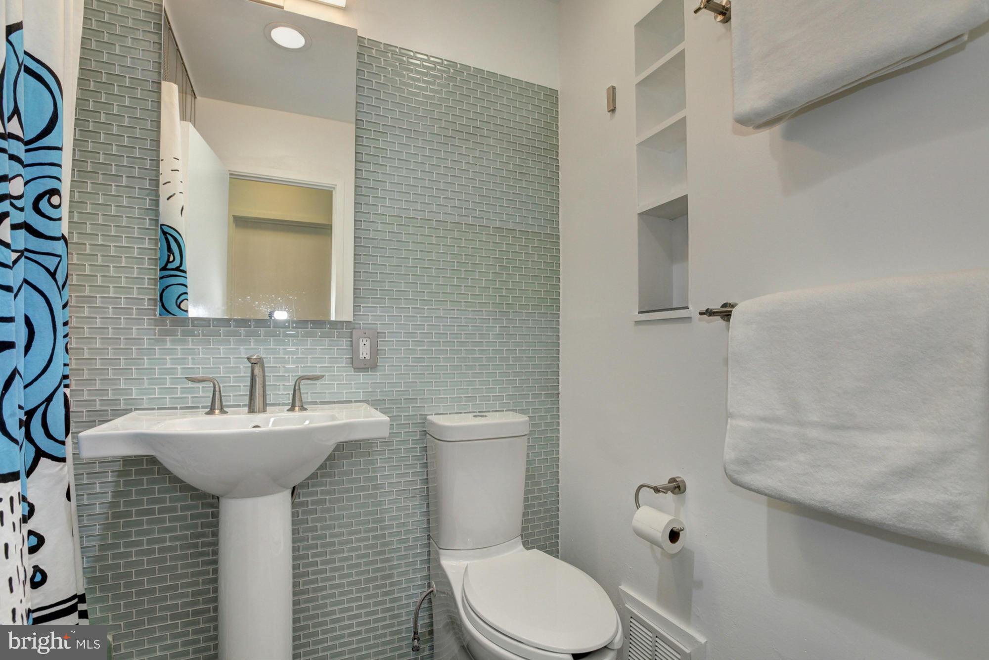 3946 Rickover Road Silver Spring, MD 20902 - Photo 19 of 30 a bathroom with a sink toilet and mirror