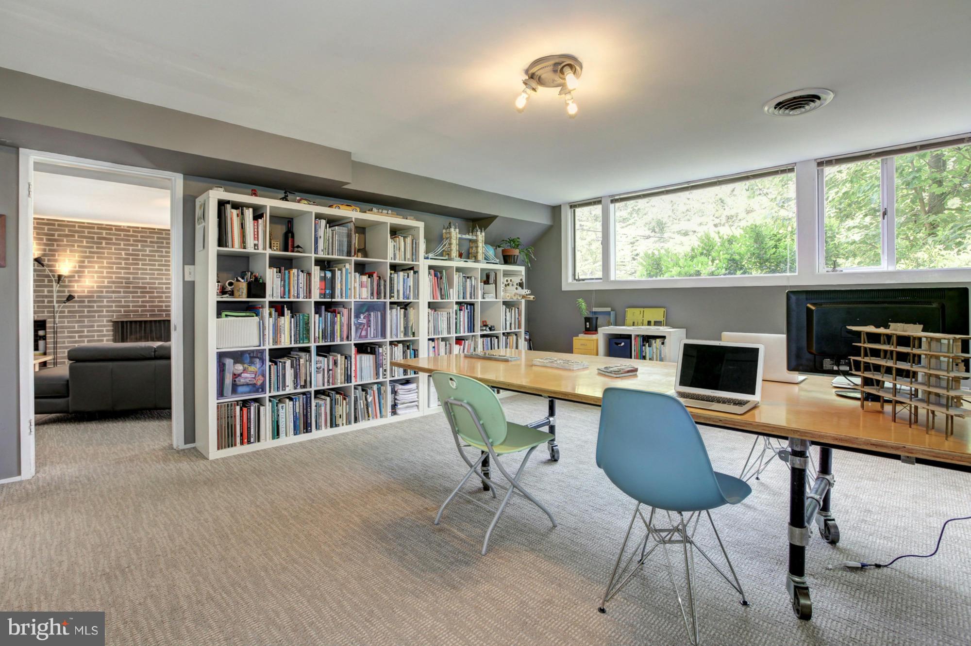 3946 Rickover Road Silver Spring, MD 20902 - Photo 22 of 30 a view of a workspace with furniture and a bookshelf