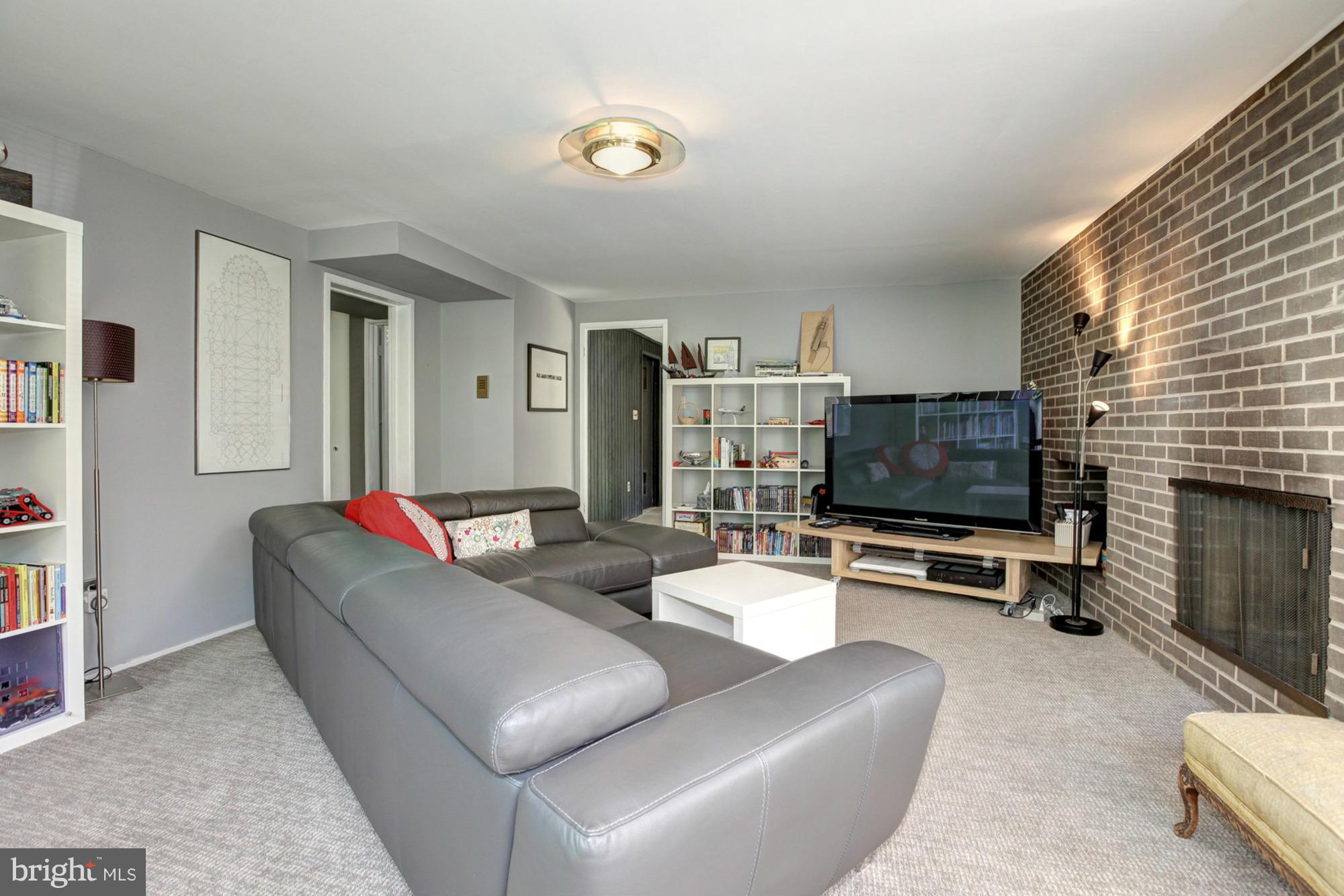 3946 Rickover Road Silver Spring, MD 20902 - Photo 24 of 30 a living room with furniture and a flat screen tv