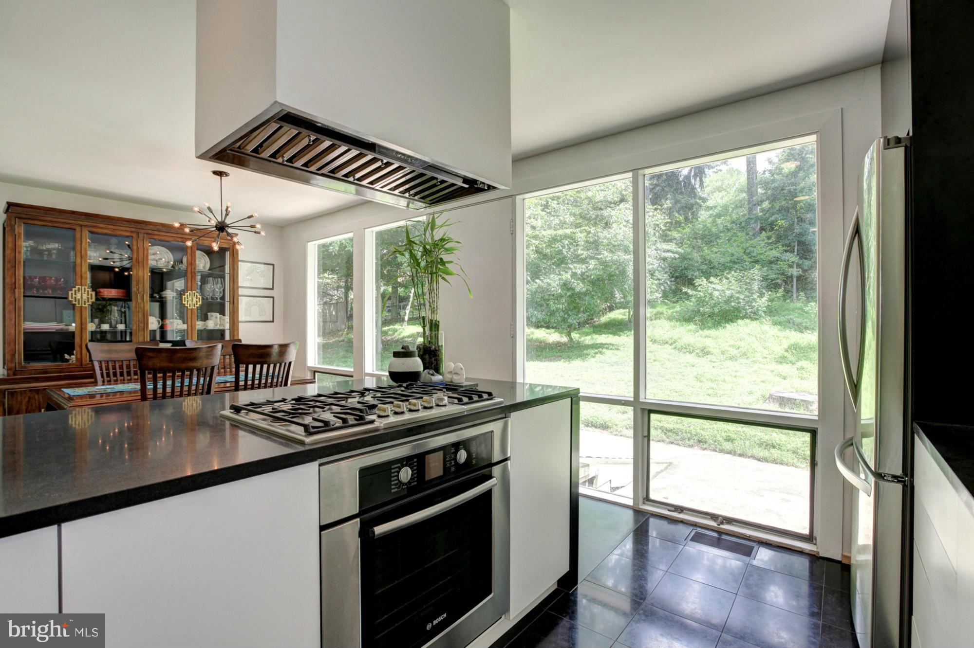 3946 Rickover Road Silver Spring, MD 20902 - Photo 8 of 30 a kitchen with stainless steel appliances granite countertop a stove and a view of dining room