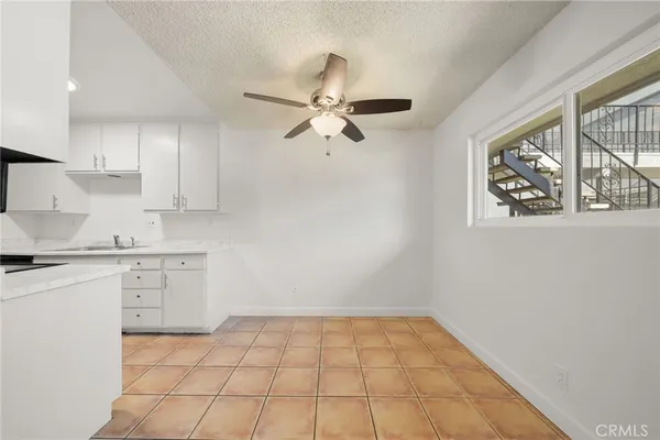 a kitchen with granite countertop a sink and a stove top oven with wooden floor