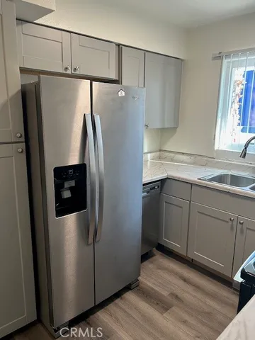 a kitchen with stainless steel appliances granite countertop a refrigerator and a sink