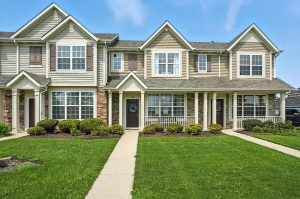 a front view of a house with a yard