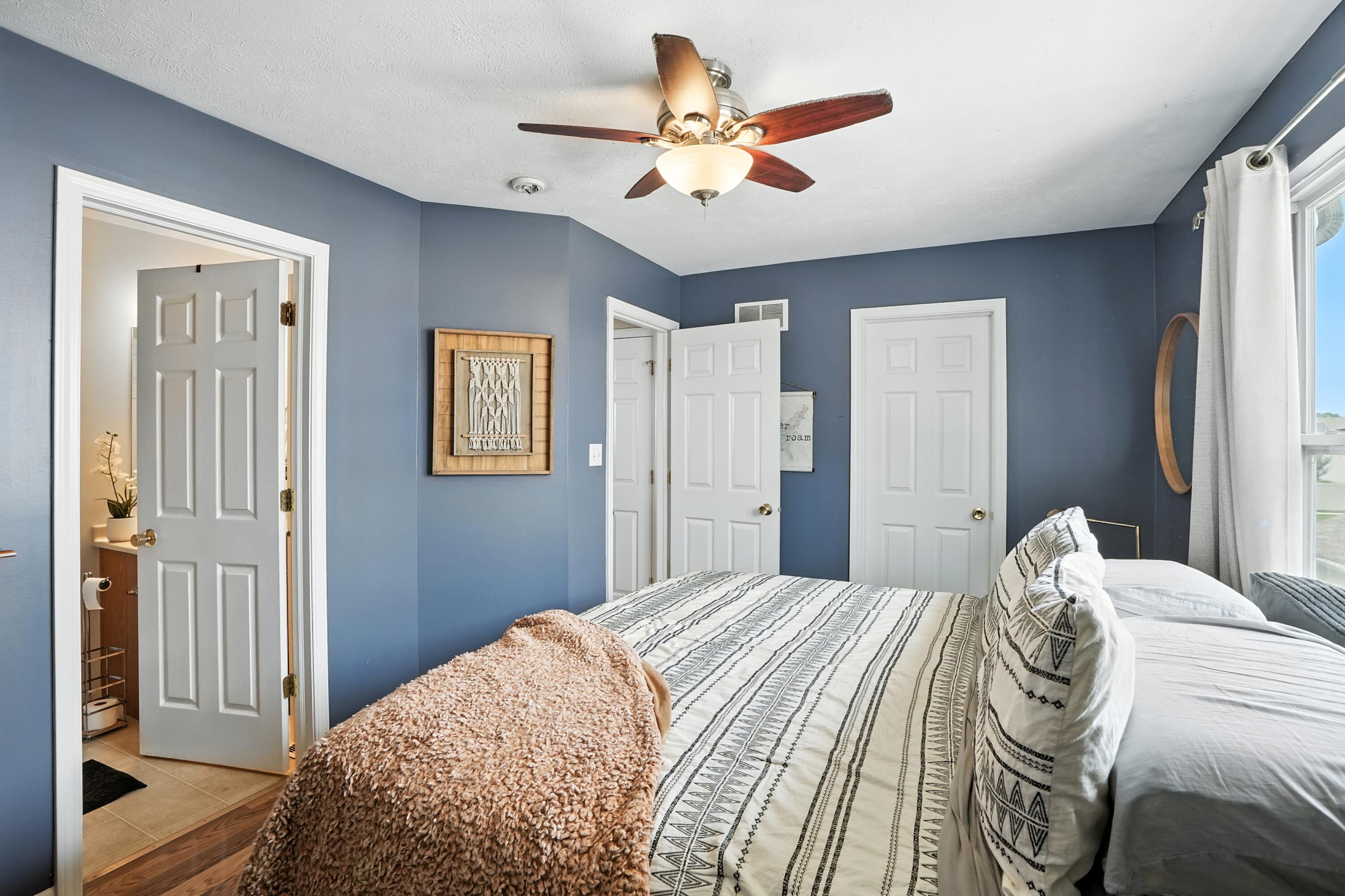 922 East 115th Place Crown Point, IN 46307 - Photo 14 of 23 a bedroom with a large bed and a chandelier