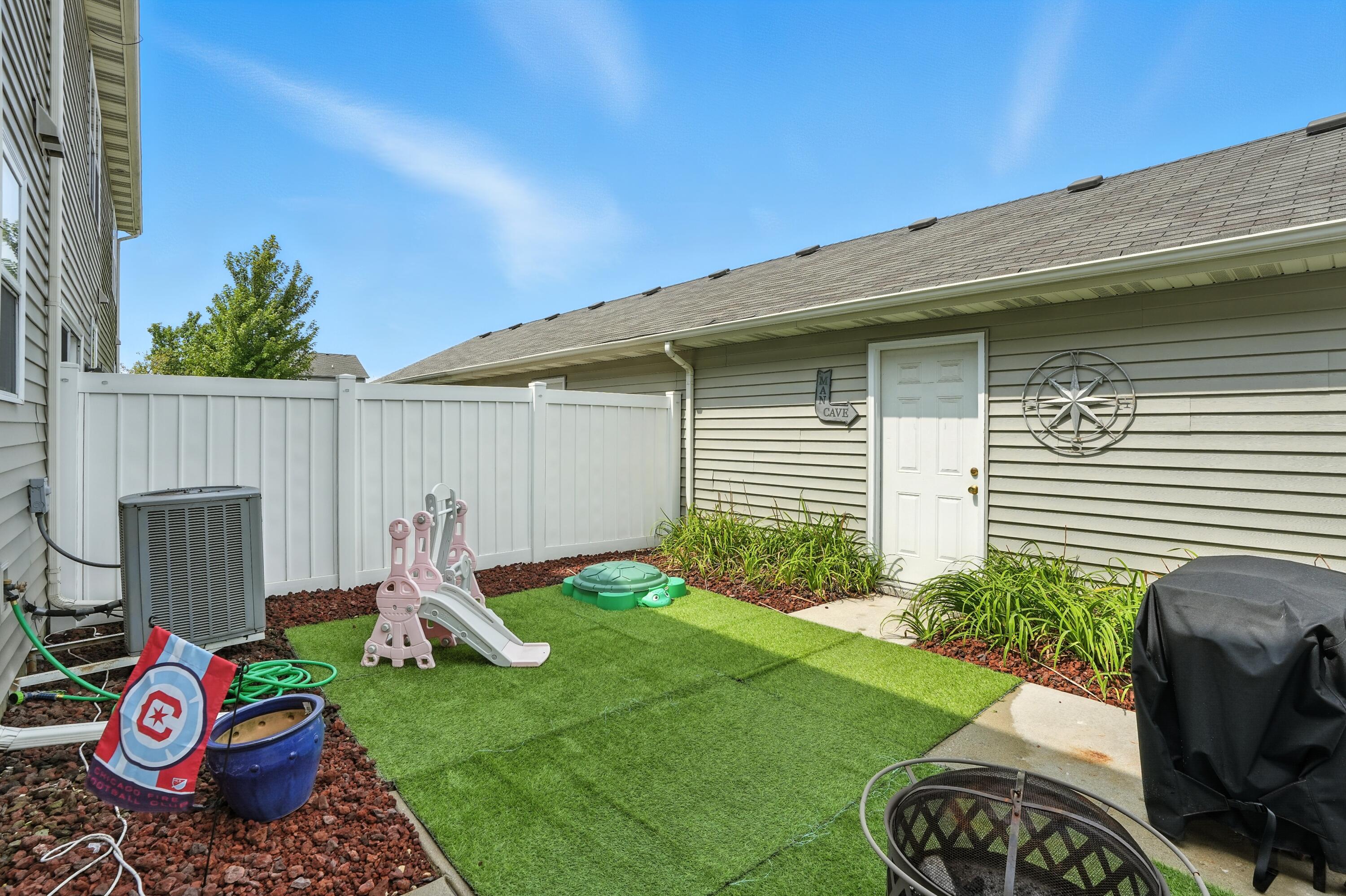 922 East 115th Place Crown Point, IN 46307 - Photo 20 of 23 a view of a backyard with furniture and a fire pit