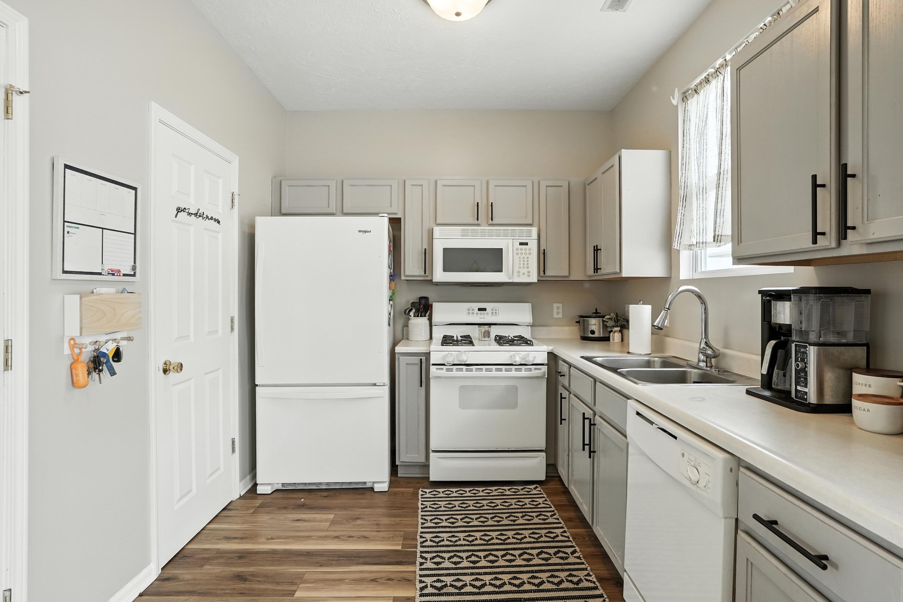 922 East 115th Place Crown Point, IN 46307 - Photo 6 of 23 a kitchen with stainless steel appliances a refrigerator sink and cabinets
