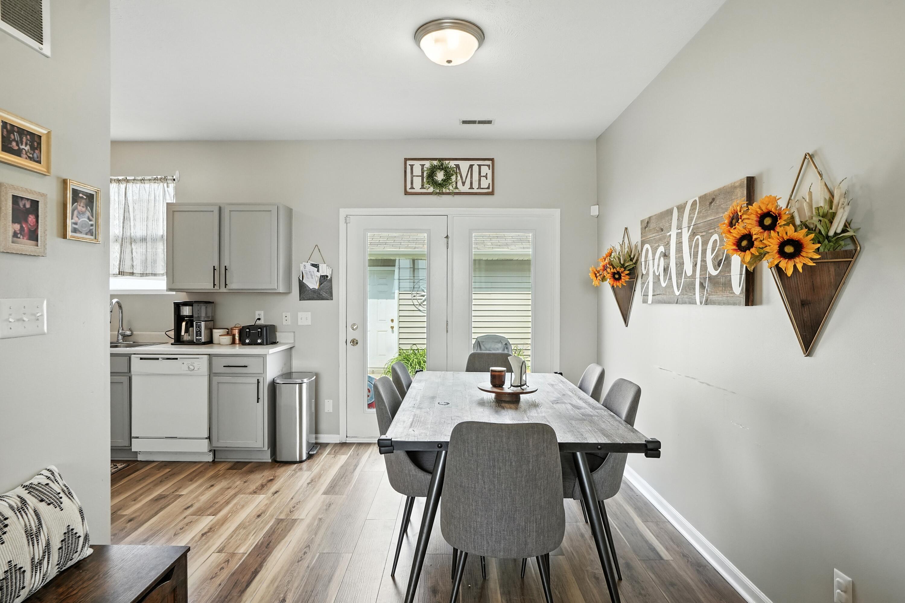 922 East 115th Place Crown Point, IN 46307 - Photo 10 of 23 a view of a dining room with furniture a kitchen and wooden floor
