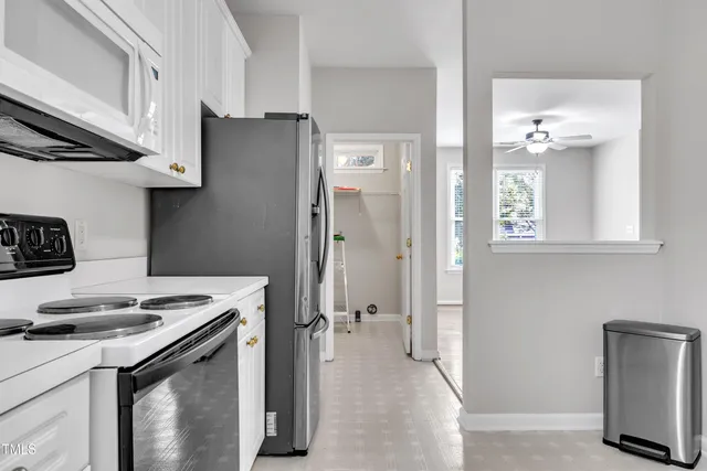 a kitchen with stainless steel appliances granite countertop a refrigerator and a stove