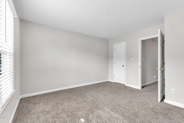 an empty room with a empty space and windows