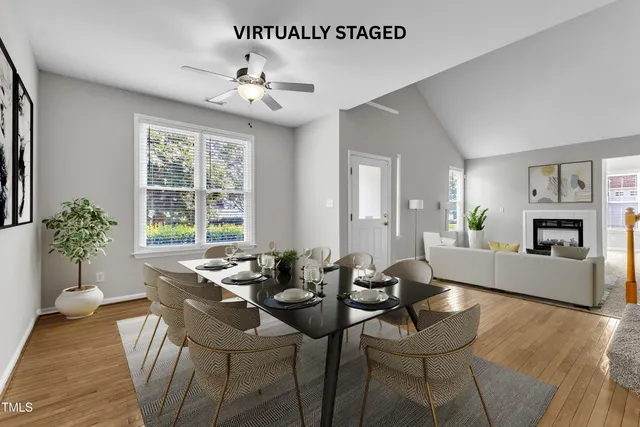 a dining room with furniture a chandelier and wooden floor