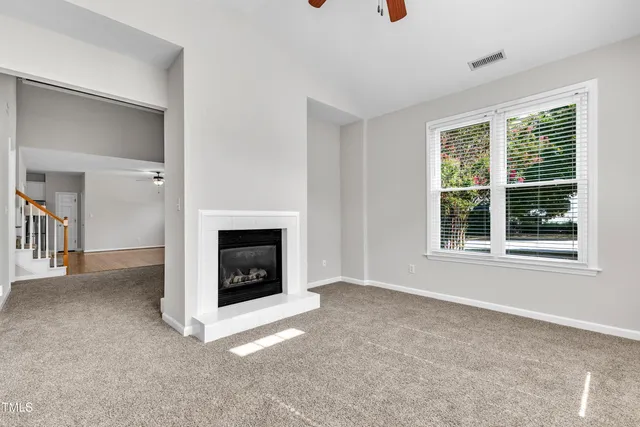 a view of a livingroom with an empty space and a window