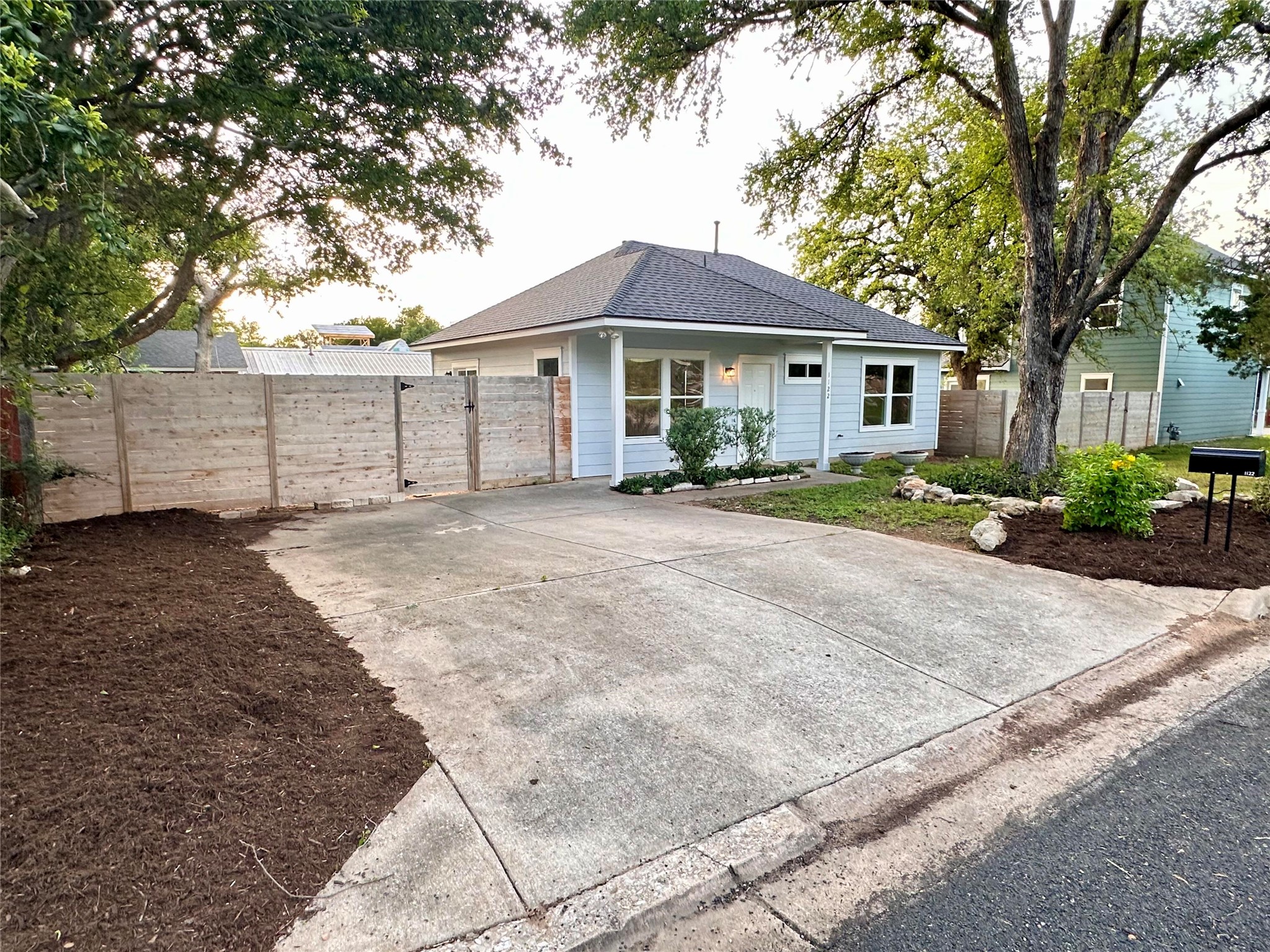 1122 Mansell Avenue Austin, TX 78721 - Photo 2 of 29 a front view of a house with a yard and garage