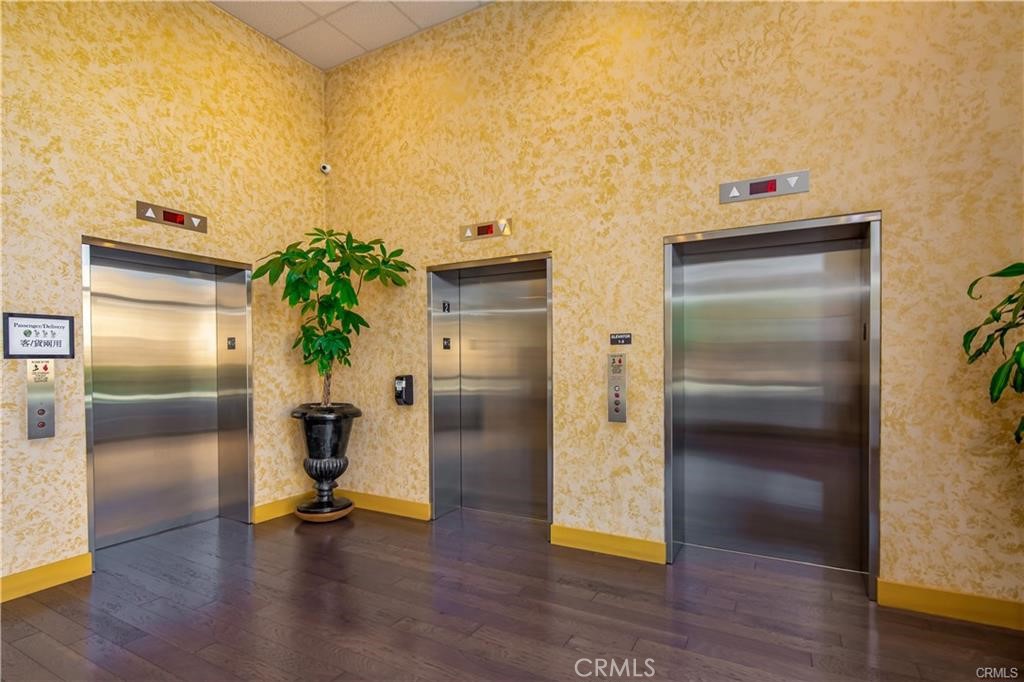 11 South 3rd Street, Unit 503 Alhambra, CA 91801 - Photo 5 of 13 a view of a hallway with wooden floor and a potted plant