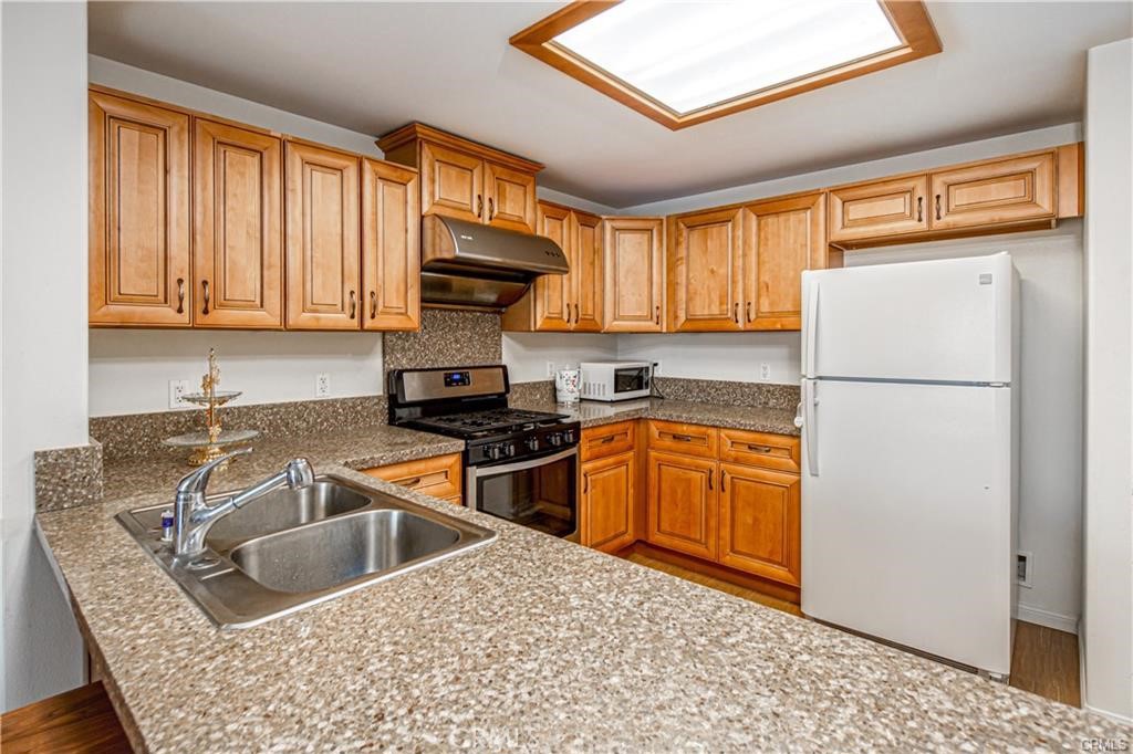 11 South 3rd Street, Unit 503 Alhambra, CA 91801 - Photo 6 of 13 a kitchen with a refrigerator sink and stove