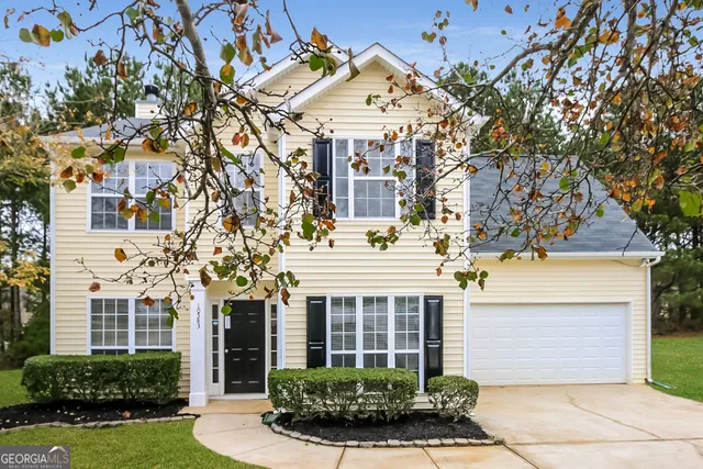 a front view of a house with a garden