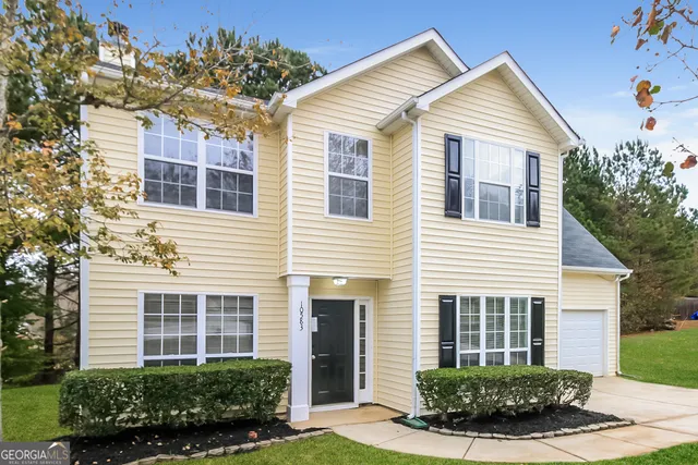 a front view of a house with a yard