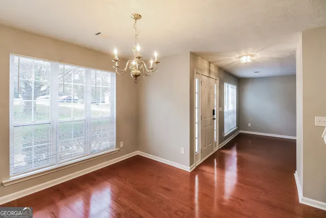 a view of a livingroom with wooden floor and a window
