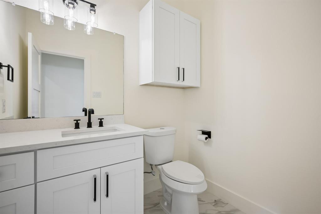 105 Buckboard Trail Oak Point, TX 75068 - Photo 20 of 27 Guest Bathroom featuring vanity and light marble finish floors