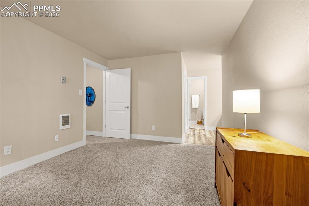 1679 Deer Creek Road Monument, CO 80132 - Photo 4 of 21 Bedroom featuring light carpet and ensuite bathroom
